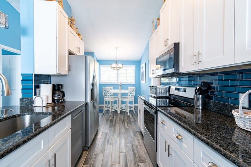 Modern kitchen with stainless steel appliances and a cozy dining nook.