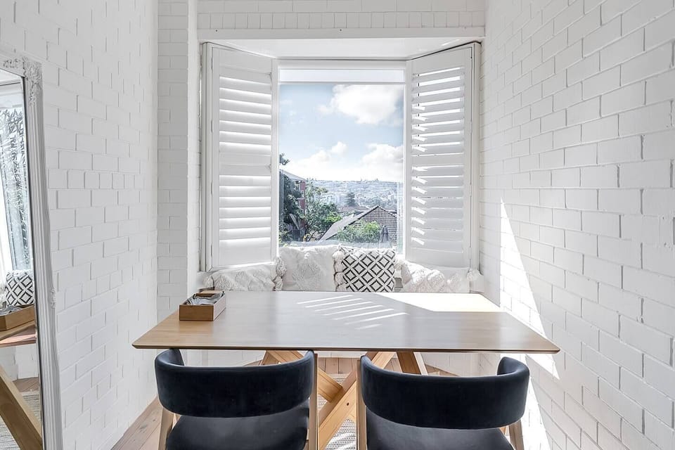 Enjoy a meal or work from home at the timber table in the tucked away dining area, offering views out across Sydney.