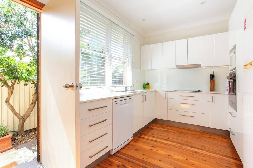 A newly renovated kitchen comes equipped with all modern appliances, including a dishwasher, fridge, oven, microwave, kettle, toaster, stove, pantry items and cooking essentials.