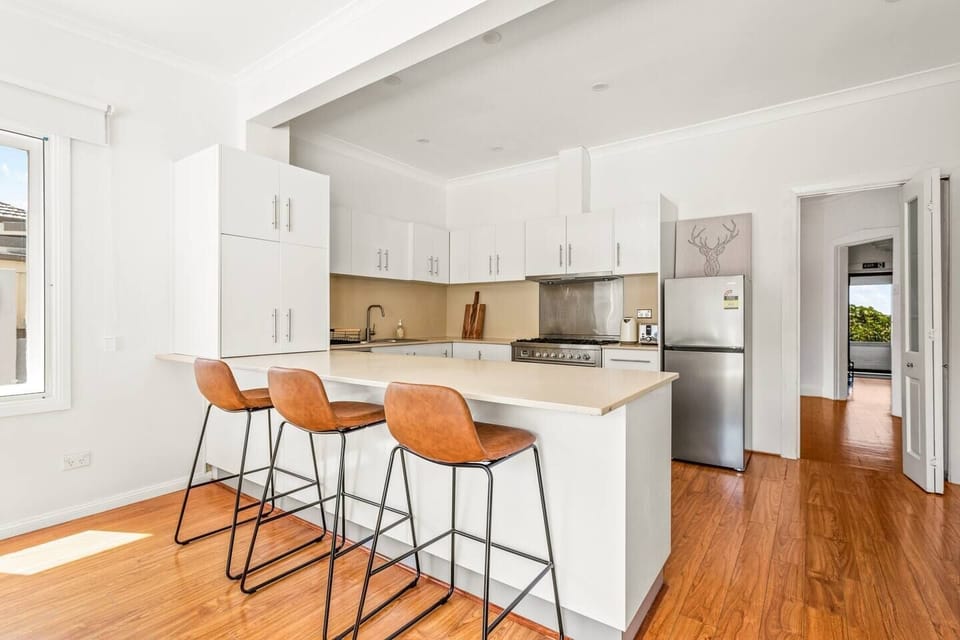 The kitchen is designed around a breakfast bar and comes fully equipped for your holiday catering.