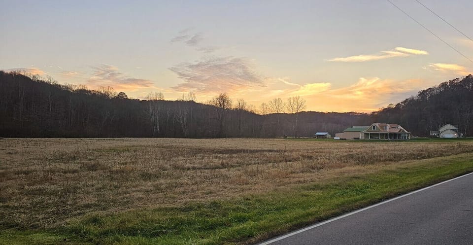 Sunset view of  the Hocking Hills Copper House and meadow.