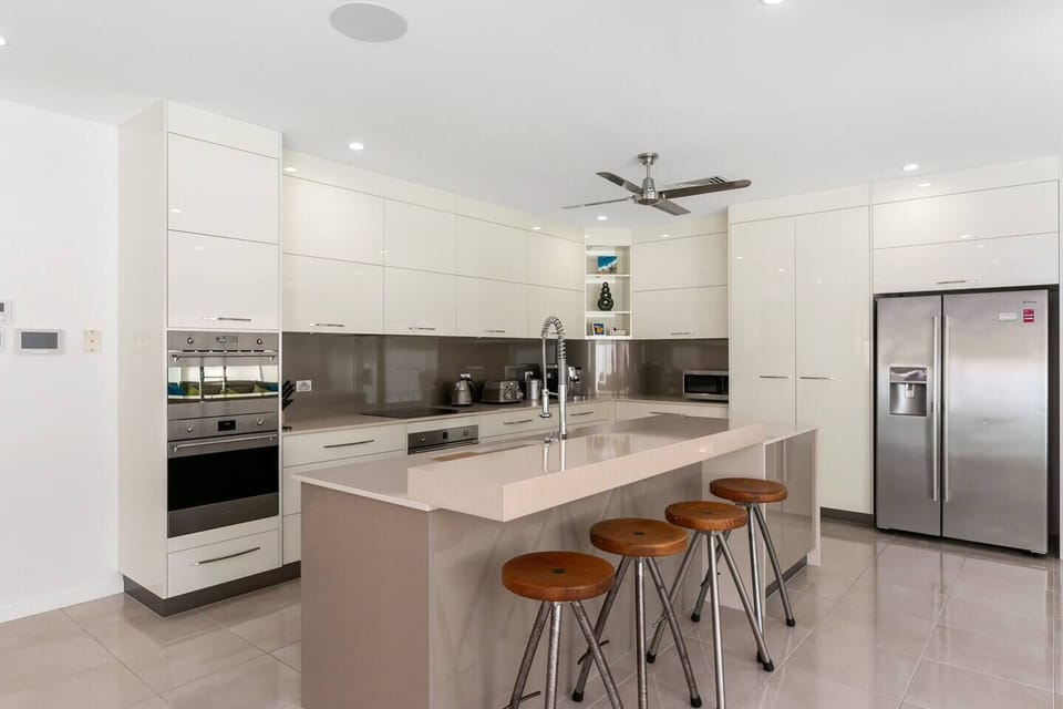 The gourmet kitchen is designed around a centrepiece island bench, where you can prepare meals, socialise or enjoy slow mornings at home.