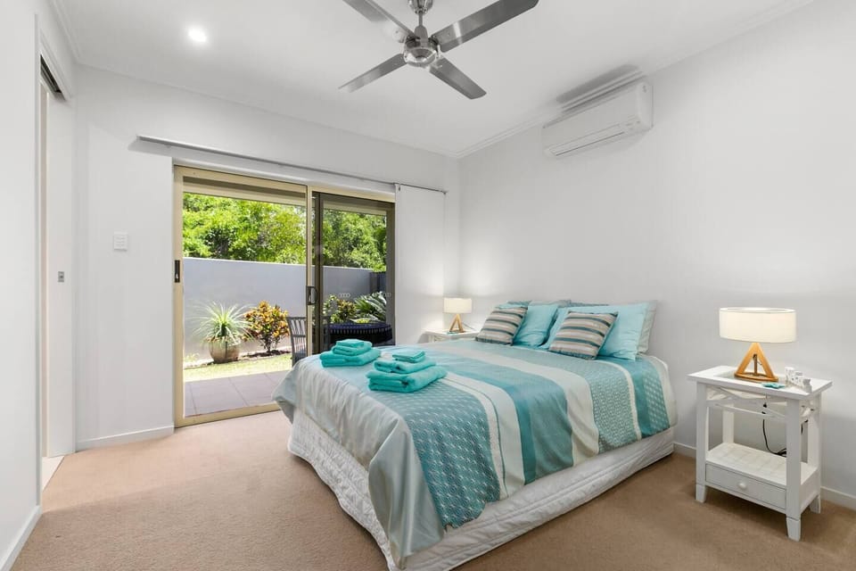 The beautiful fourth bedroom has a queen-sized bed and flows to a private undercover sitting area within the garden. 