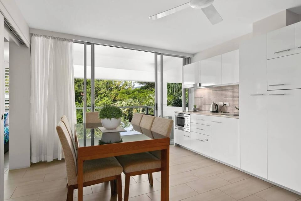 A large indoor dining table is set for six allowing guests ample space to come together for shared meal.