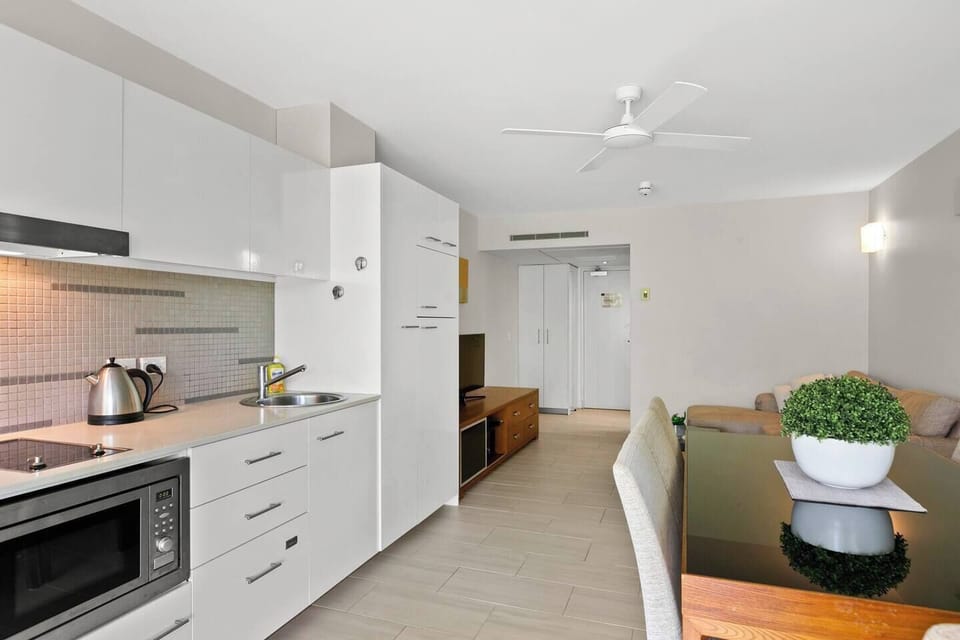 The compact kitchen is equipped with the appliances and utensils you'll need to cook a meal at home. It includes a fridge, stove, microwave and dishwasher.