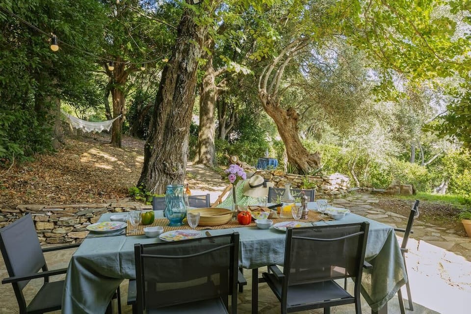 Terrace furnished with garden furniture, dining table, and charcoal barbecue