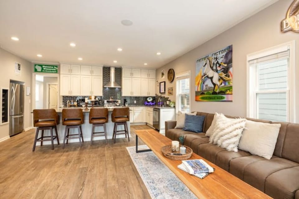 Spacious indoor hangout with oversized seating, games, and large TV for groups