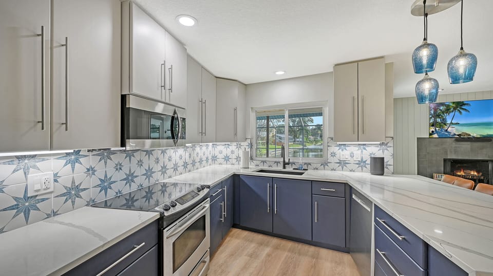 Kitchen countertop with decorative tile backsplash and pendant lighting