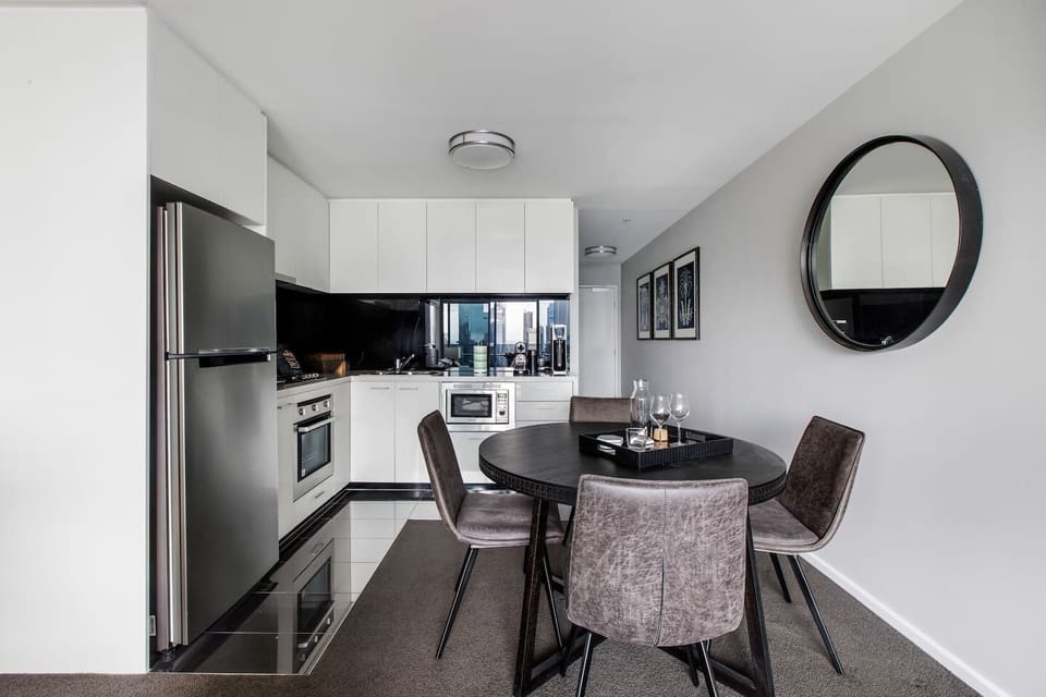 The open-plan kitchen and dining area includes a four-seater table where you can dine at home.