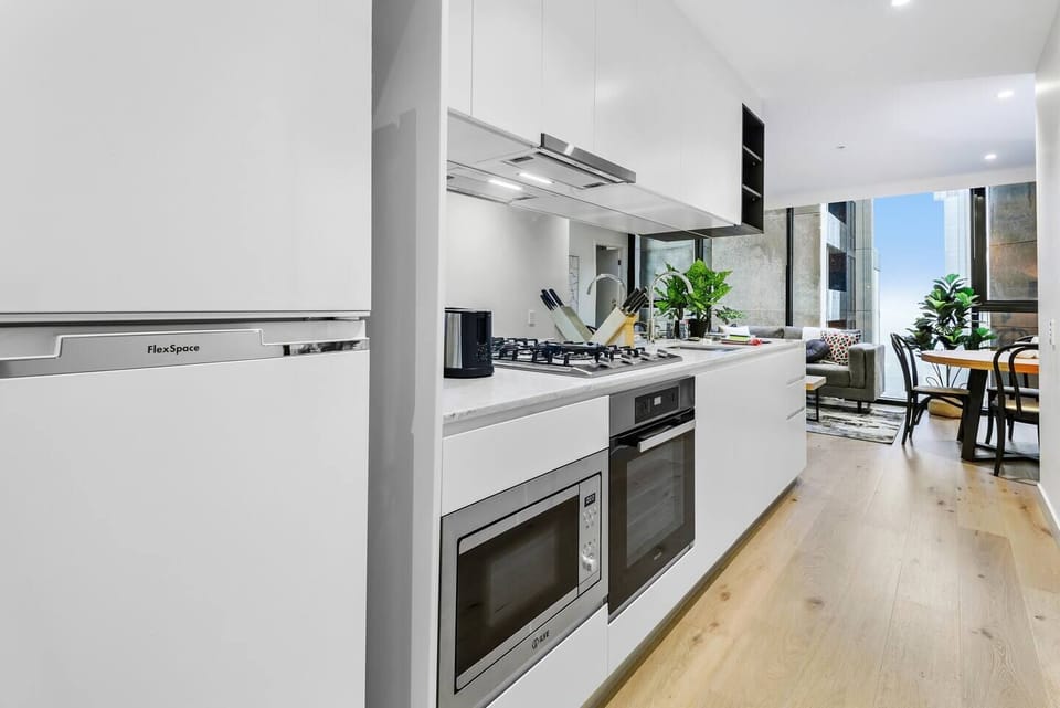 The streamlined kitchen has everything that’s needed to prepare meals at home, including a dishwasher for easy clean-up.