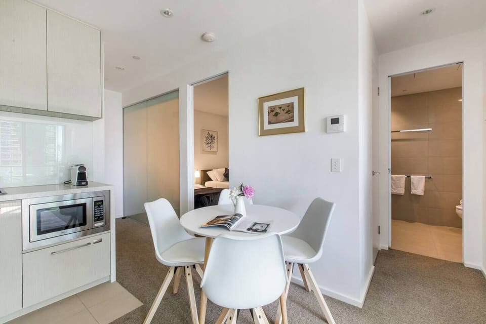 The open-plan kitchen and dining area offers a four-seater table where guests can share meals.