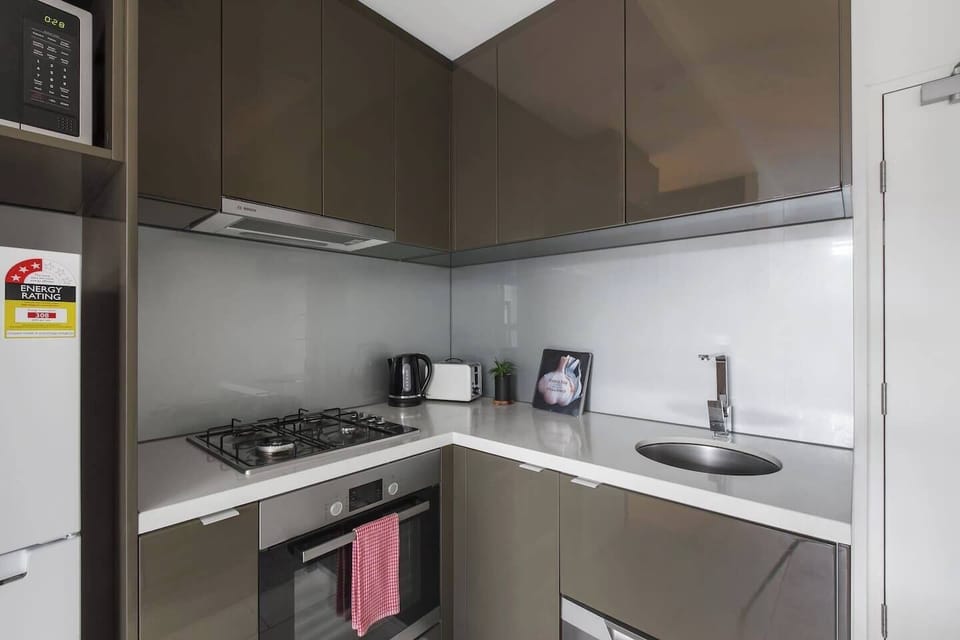The kitchen is equipped with the basics to enjoy meals at home, including a toaster, oven and a full-sized fridge.