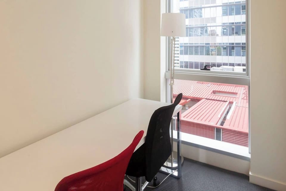 A dedicated workspace equipped with ergonomic chairs and flooded with natural light is the perfect spot to set your laptop up.
