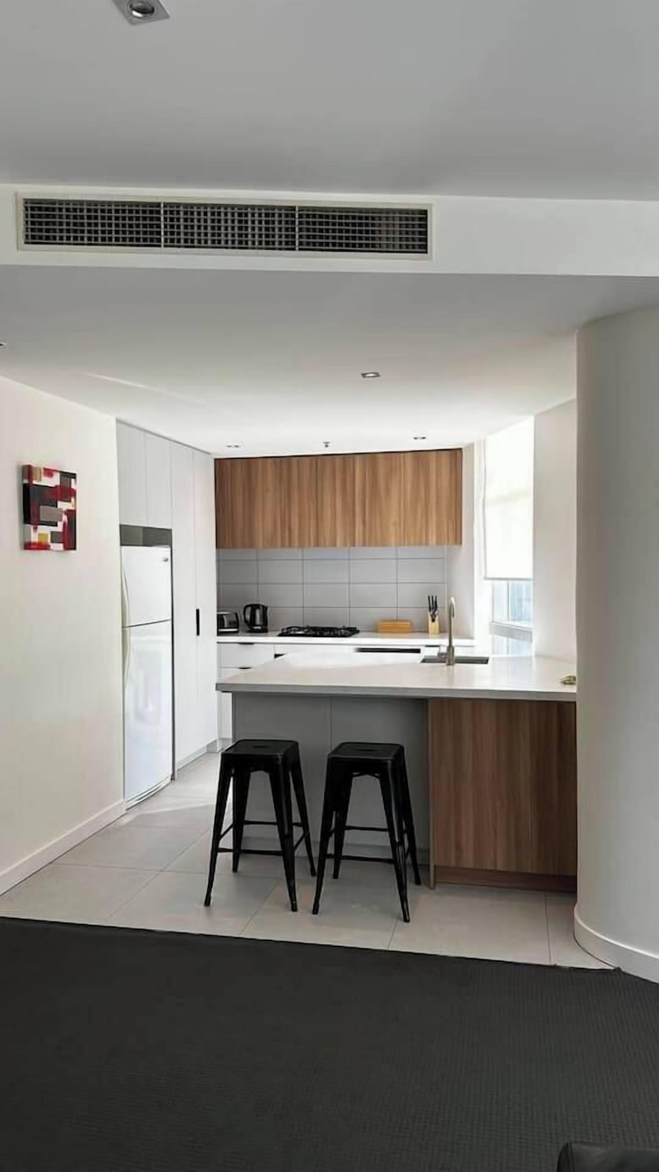 The corner kitchen offers all the essentials to whip up a meal at home.