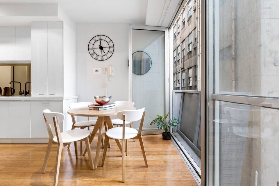 A modern dining table seats four where you can stay in and join together for a meal.