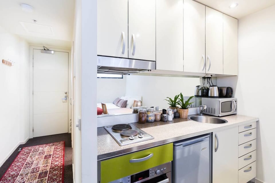 The kitchen is small, but offers everything you'll need to cook at home, including a two burner stove, full-size oven, mini fridge, microwave, hot water kettle and toaster.