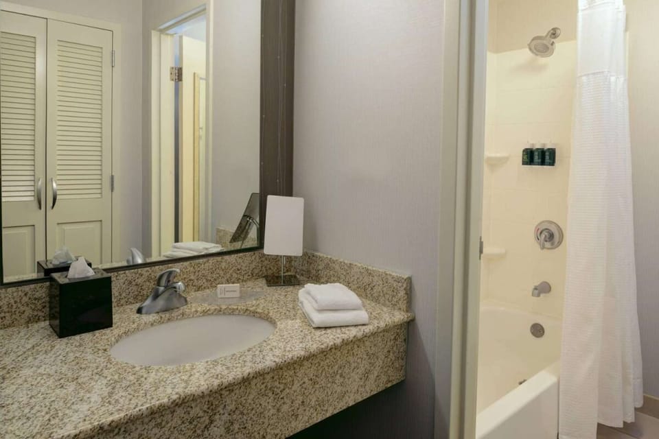Refresh easily with a spotless vanity and bright shower-tub combo.