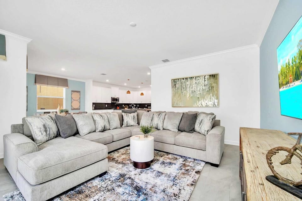 Relax In This Spacious Living Room With A Stylish Sectional Sofa