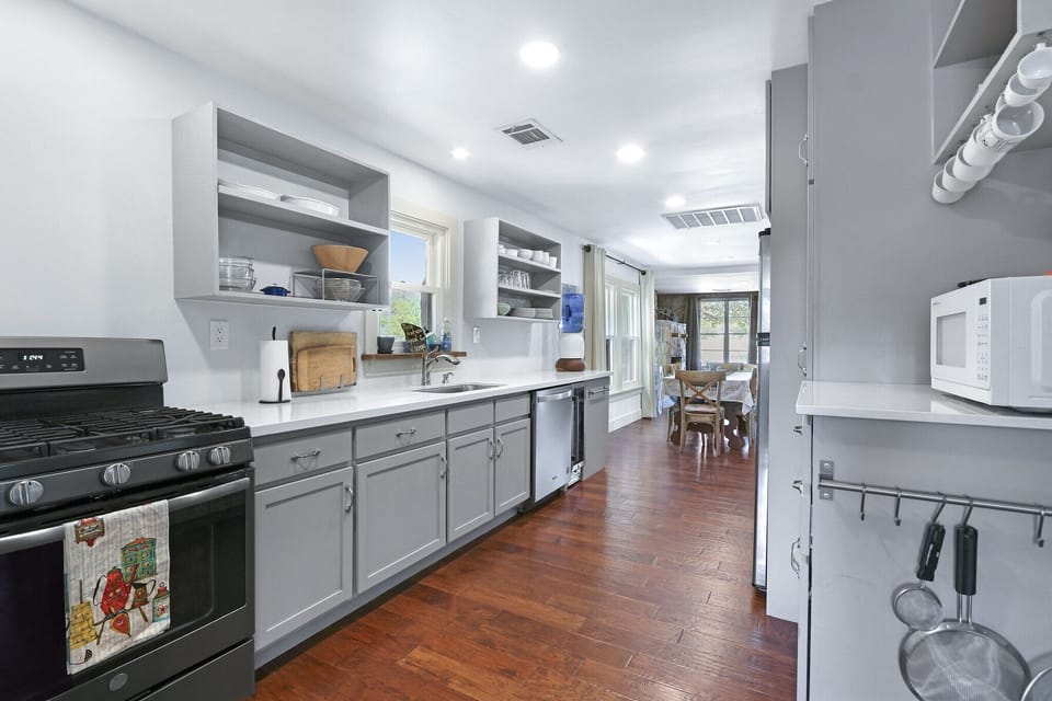 Galley style kitchen, fully stocked with stainless steel appliances
