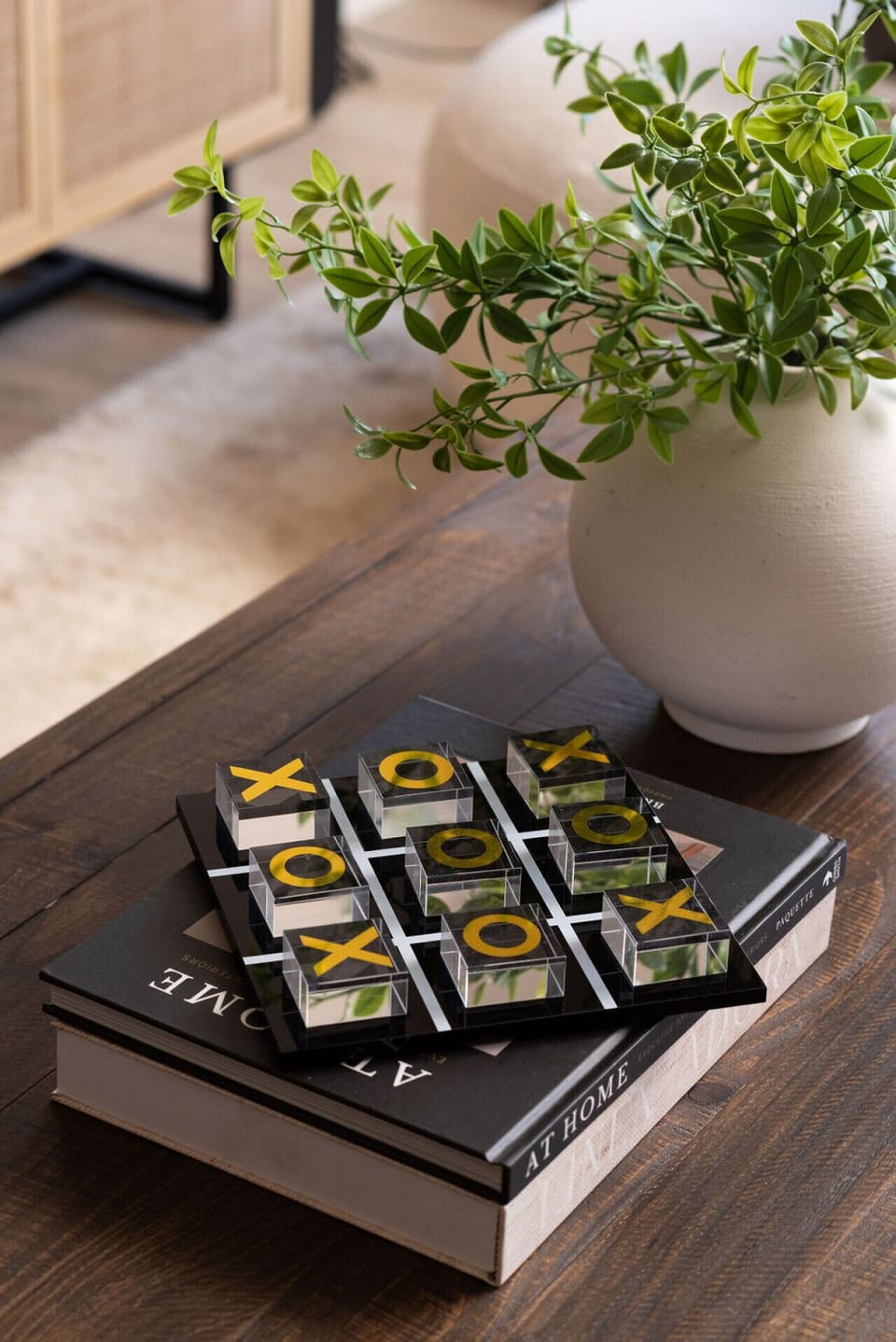 Decorative coffee table detail with a tic-tac-toe game and stylish accents.