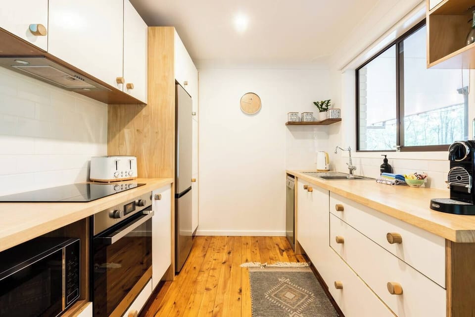 This modern-Scandinavian style kitchen provides everything you need for a meal at home.
