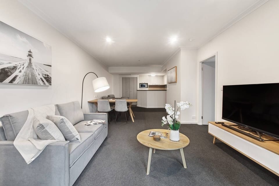 The open plan apartment includes a four-seater dining table and lounge area.