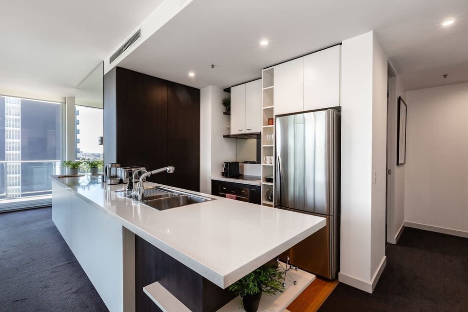 The kitchen is compact but fully-equipped and benefits from an oversized island.