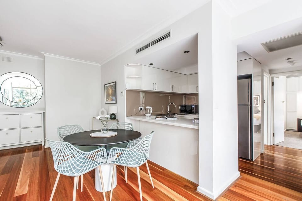 An open-plan dining space includes a four-seater table where guests can share meals.