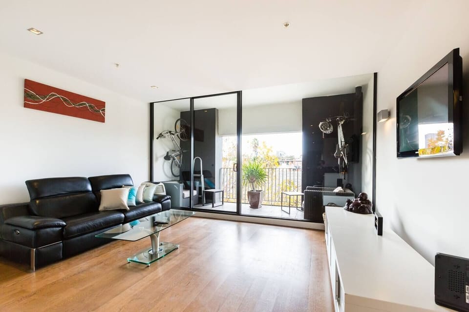 Unique artwork and decor are complimented by timber floors throughout the apartment. 