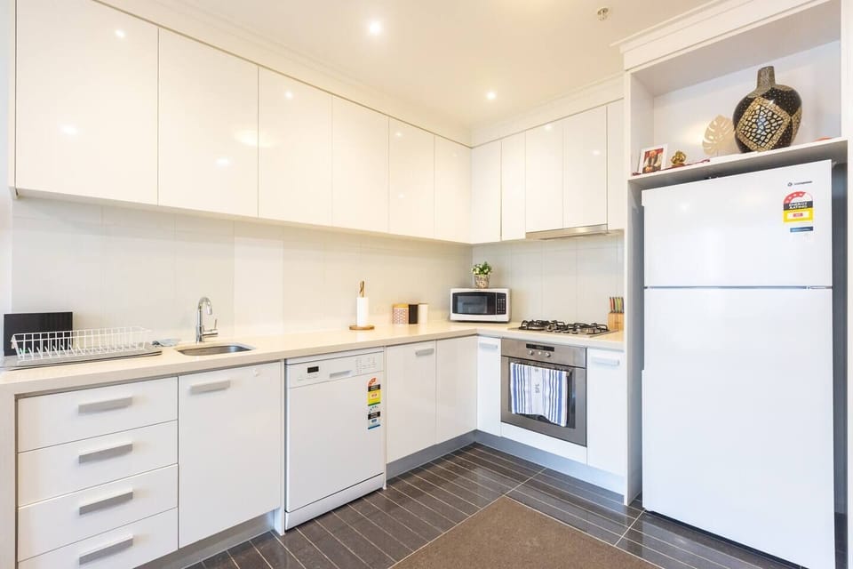 The L-shaped kitchen is fully-equipped with everything you'll need to cook at home, plus a dishwasher for easy clean up.