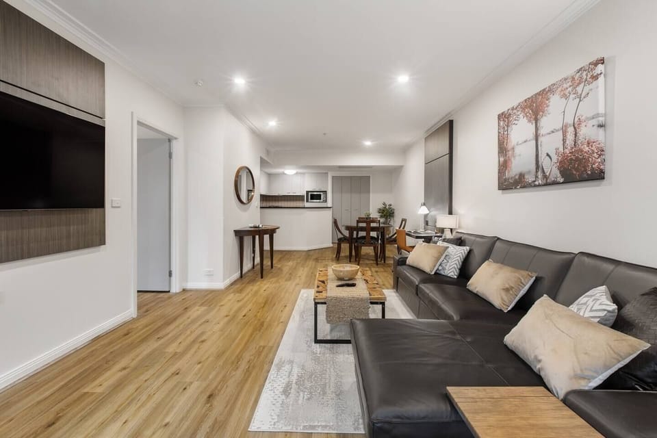 The open plan apartment includes a four-seater dining table and lounge area.