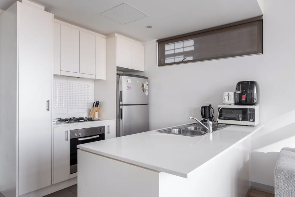 Cook comfortably in the kitchen, equipped with a gas cooktop, oven, dishwasher and generous bench space for everyday meals.
