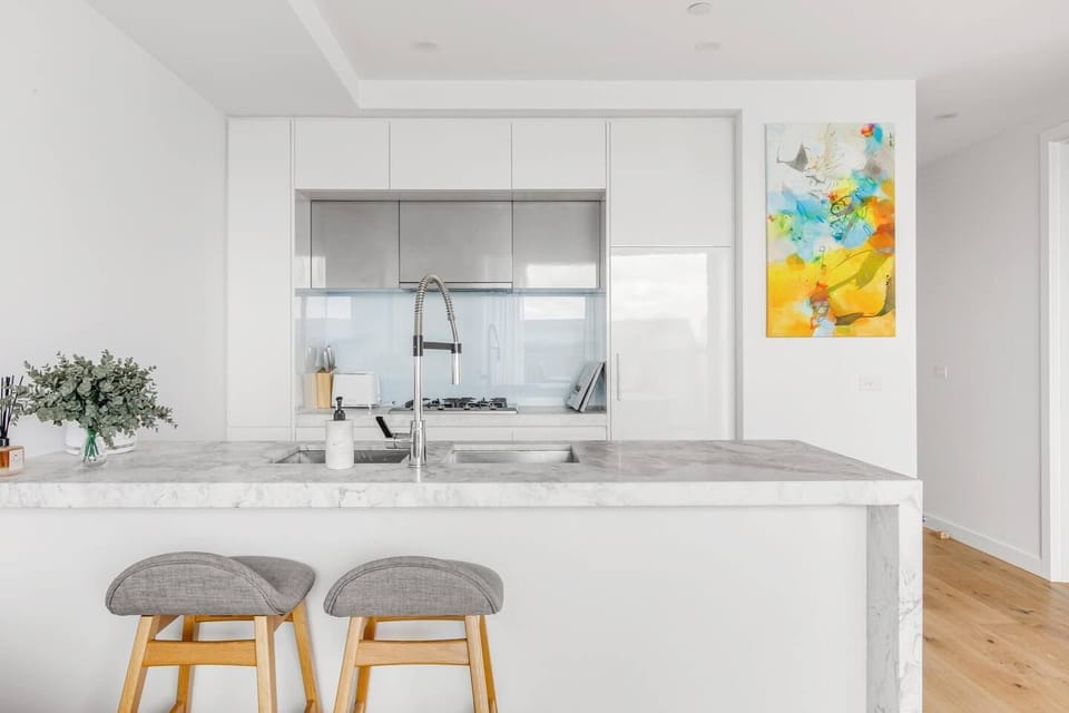 A sleek stone kitchen makes it easy to prepare meals at home with modern appliances and cooking utensils.
