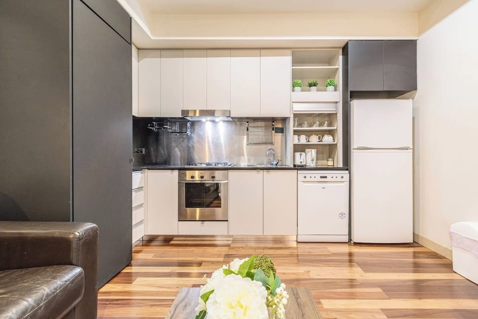 Cook simple meals with ease using the full kitchen featuring a stovetop, oven, microwave, dishwasher, and pantry basics.