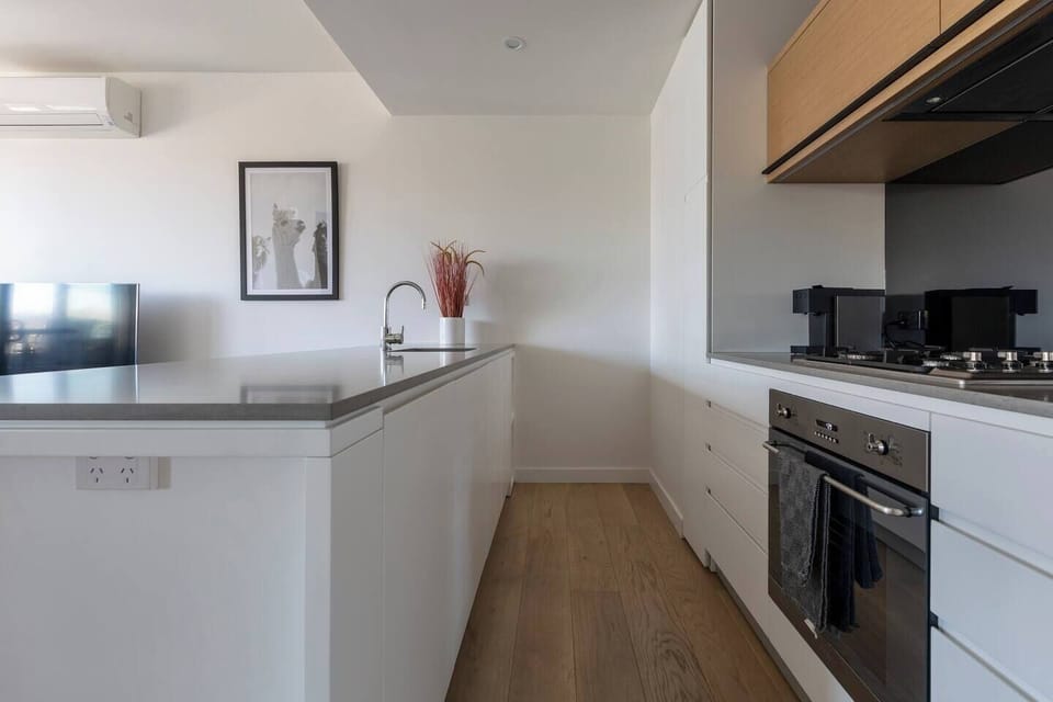A fully-equipped kitchen has a gas stovetop, oven and refrigerator, along with other bonuses like a coffee machine and a toaster