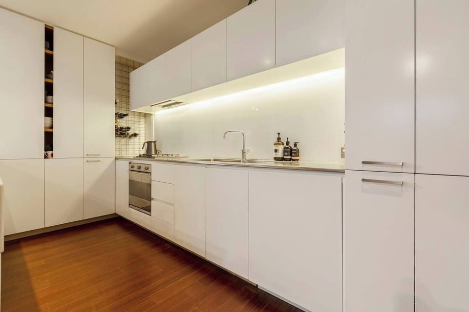 A contemporary, fully-equipped kitchen has a gas cooktop, all the modern appliances as well as all the necessary cooking utensils