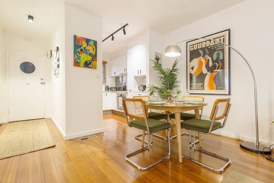 The open plan kitchen and dining room is decorated with Mid-Century styling to create a warm welcome.
