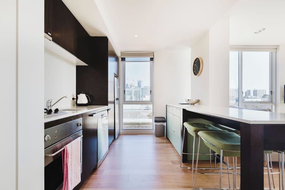 A bright, fully-equipped kitchen has premium appliances including an oven, gas stove and refrigerator