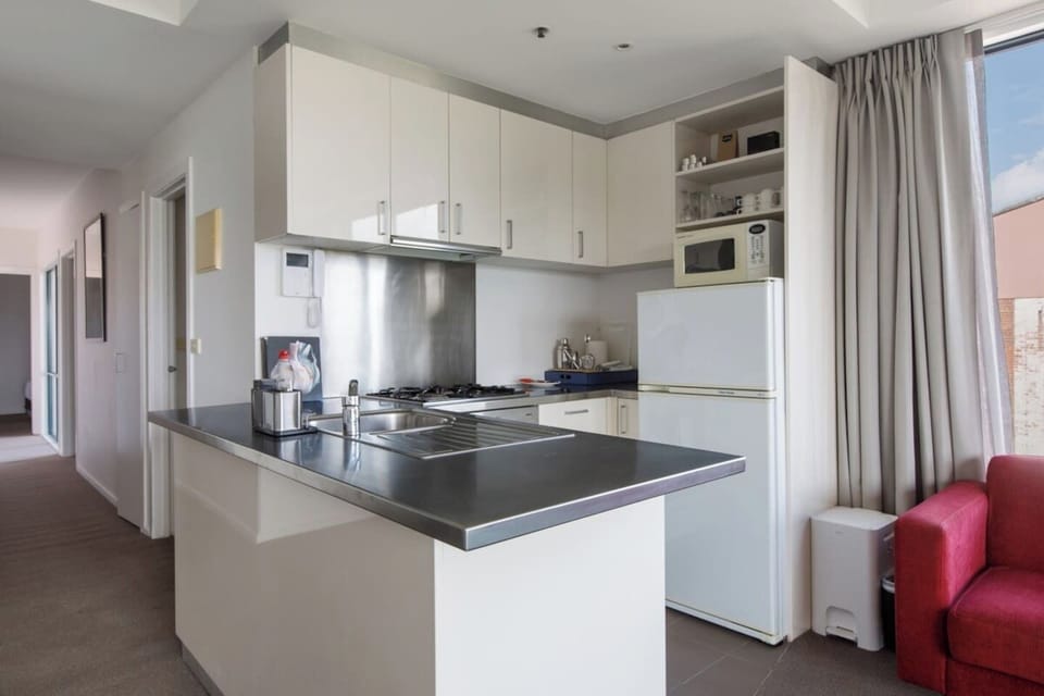 The open kitchen offers all the essentials needed to prepare meals at home. 
