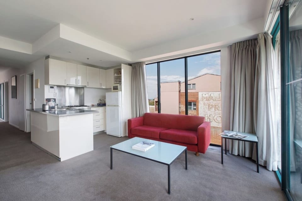 A bright and airy living and dining area features a sofa where guests can kick back and unwind with a movie.