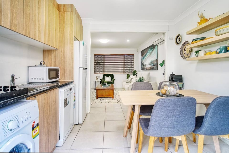A kitchenette is fitted with a dishwasher, stovetop, microwave and the basic cooking utensils