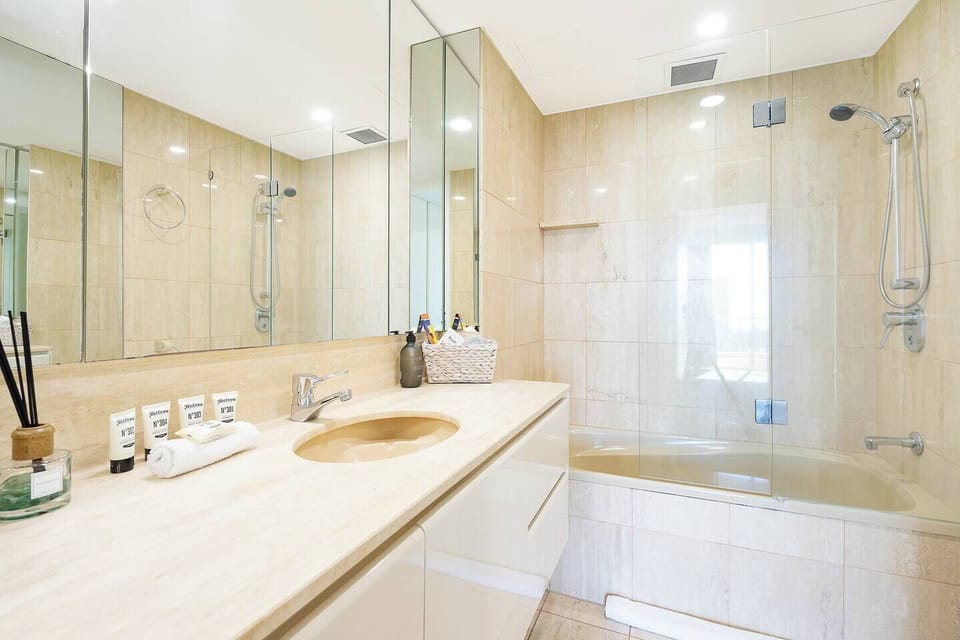 The second bathroom, decked in marble, has a great tub and shower, large vanity and complimentary toiletries