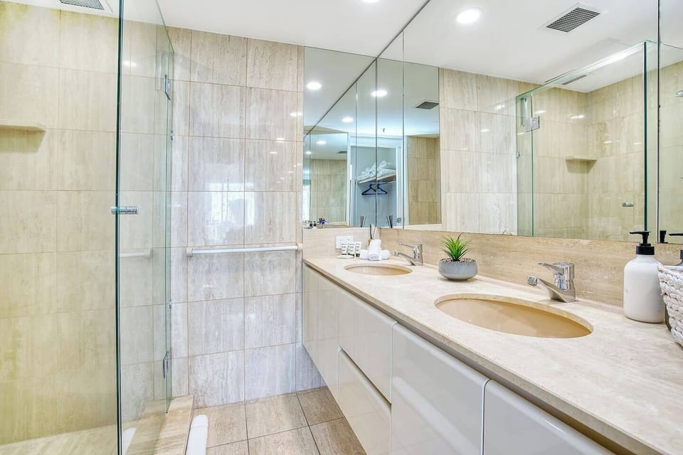 The large master bathroom, decked in marble, has a huge walk-in shower, complimentary toiletries and large vanity with his and hers dual sinks