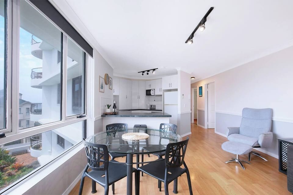 A four-person dining table and breakfast bar make it easy to come together for a meal at home.
