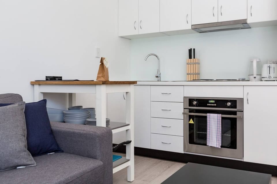 The compact kitchen is fully equipped with everything you need to cook a meal at home - stove, oven, fridge,  microwave, kettle and toaster. 
