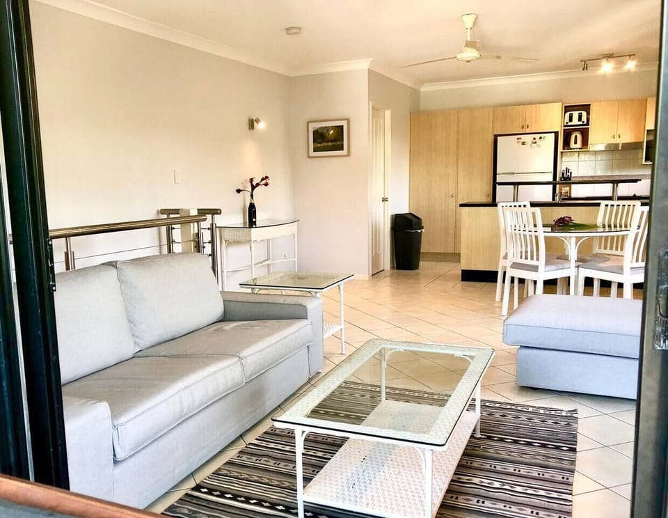 The spacious living area is fitted with comfortable sofa seating, TV and four-person dining table where you can sit down to a meal at home.