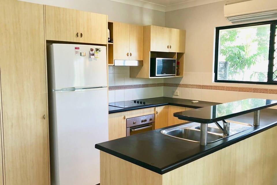 The kitchen is equipped with everything you need to cook meals at home, including a fridge, oven, stove and microwave. 