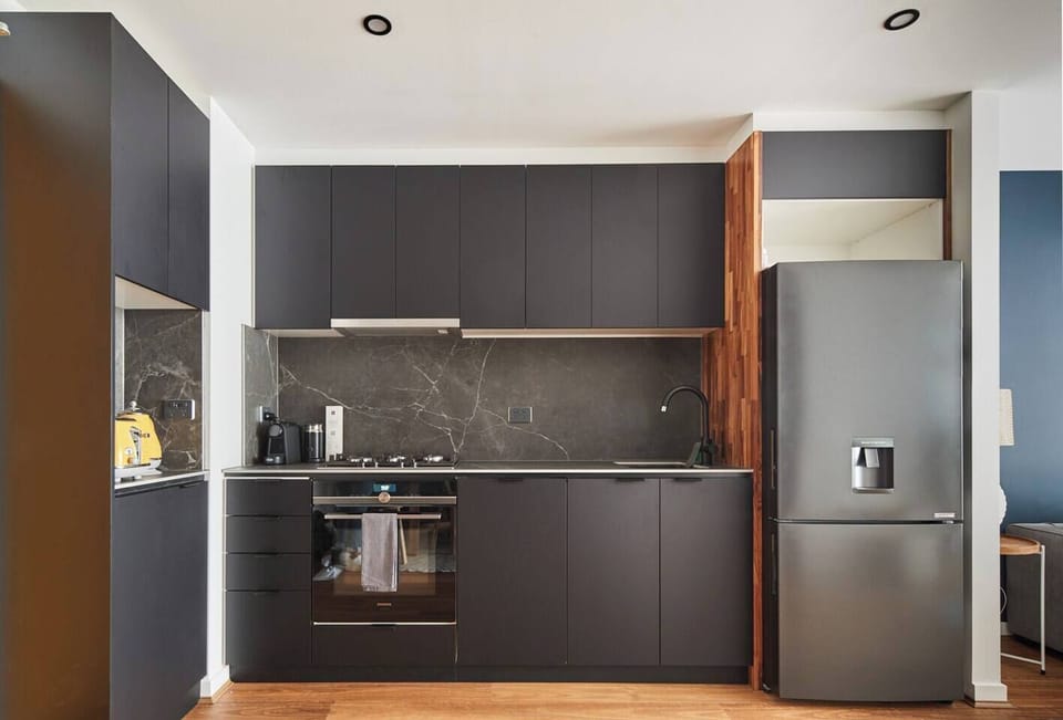  A sleek kitchen makes it easy to whip up a meal at home, or find plenty of eateries close by.
