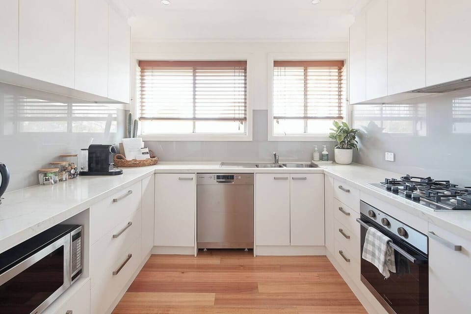 A fully-equipped kitchen fitted with appliances like an oven, large fridge, gas stove and dishwasher as well as all the essential cooking utensils and crockery