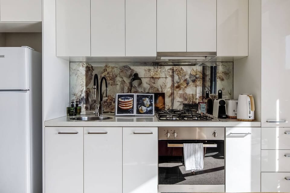 The compact kitchen allows guests to whip up a meal at home with an oven, stove and fridge